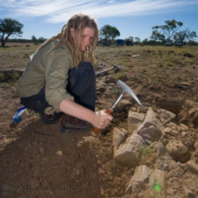 PhD Candidate Tamara Fletcher unearthing a 101 million year old log of silicified wood near Isisford, central-western Queensland. Photo: Steve Salisbury.